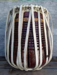 Large cracks on the shell of a tabla dayan showing through the lacing.