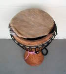 A goat skin djembe drum head with a huge tear.