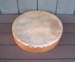 Frame drum with a torn goat skin drum head.
