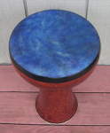A ceramic doumbek with a fresh goatskin drum head that's been dyed blue.